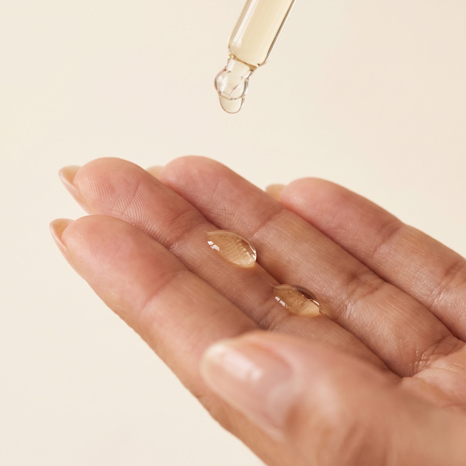 Drops of OzoMD ozonated olive oil elixir on skin